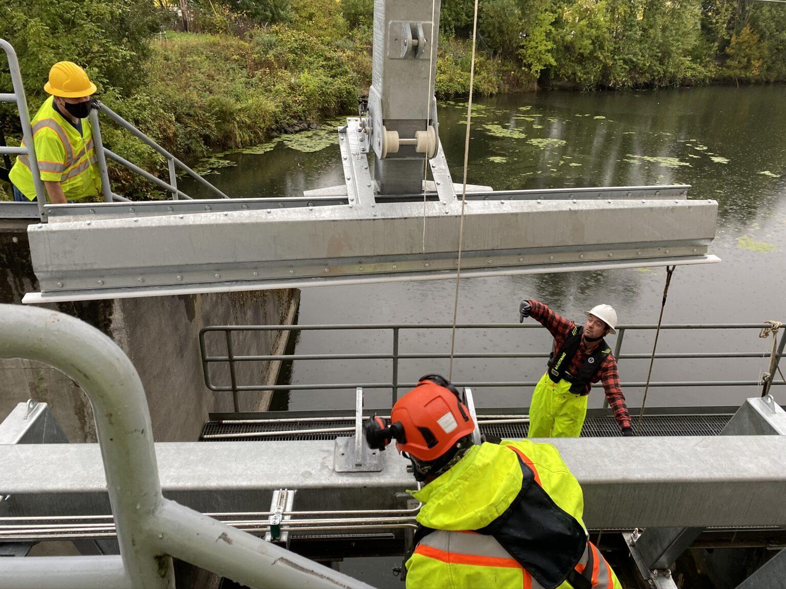 Crew installing a trash crake